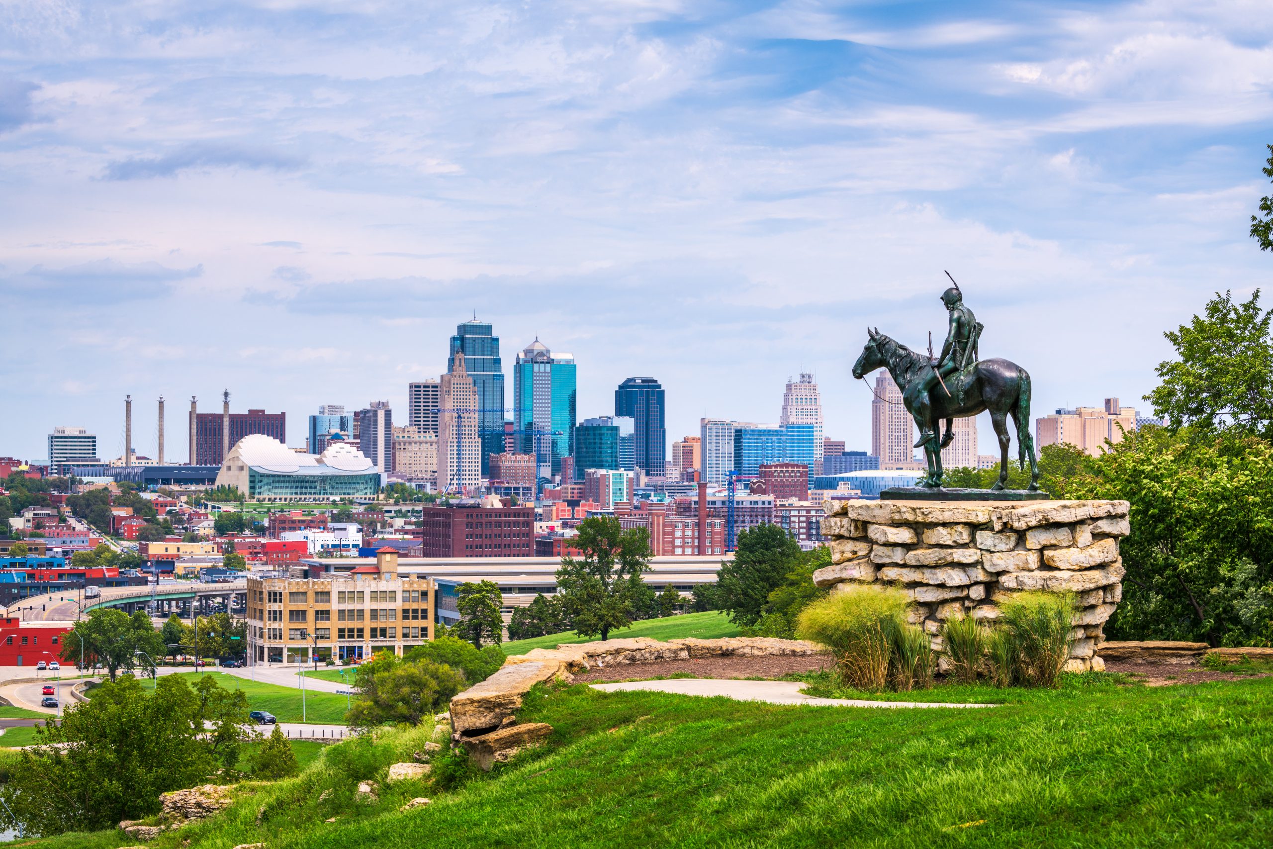 A photo of Kansas City, Missouri, behind the vantage point of a statue of a man on a horse.