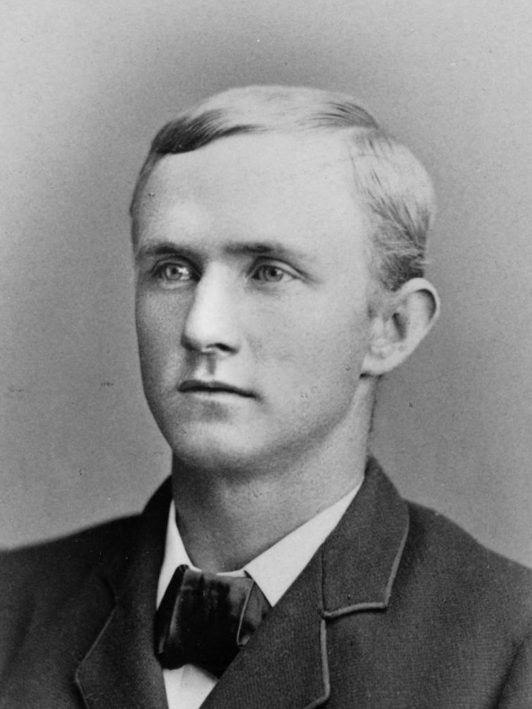 A black and white photo of a young man.