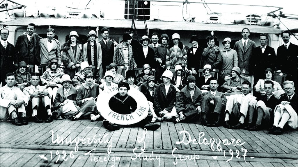 A black and white photo of a group of students on a boat.