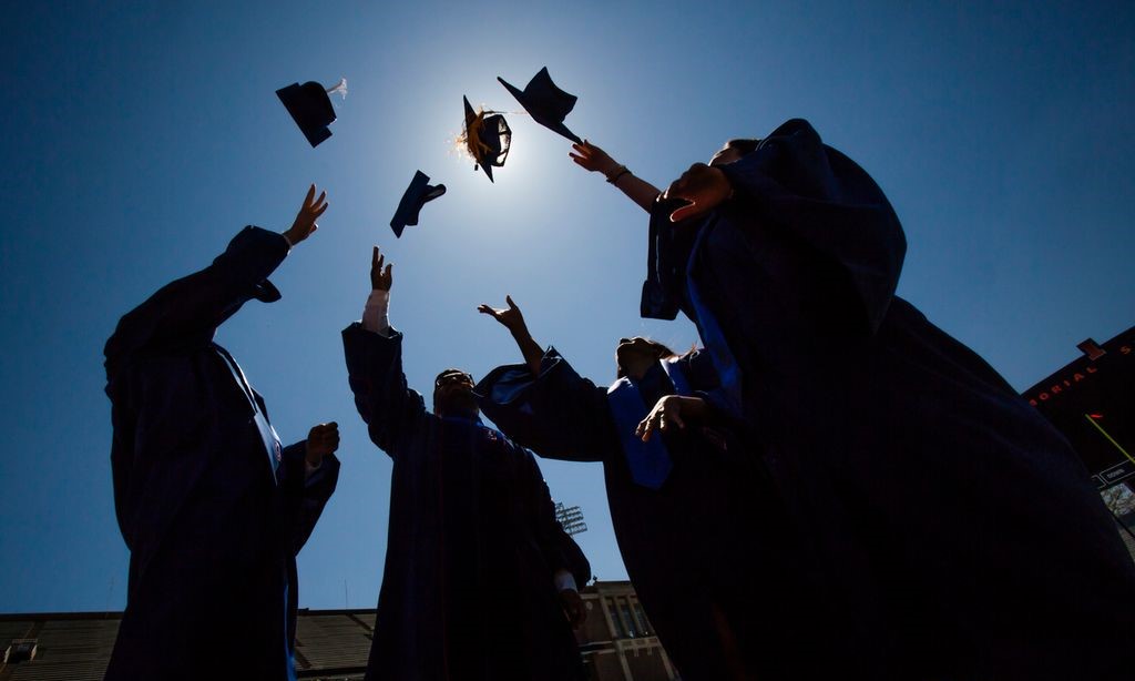 Image of graduates throwing caps